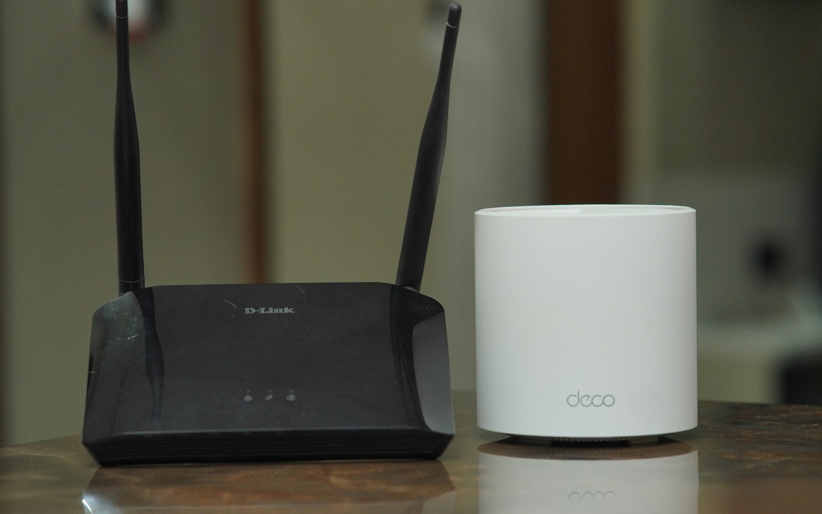Traditional Wi-Fi router beside a mesh networking unit