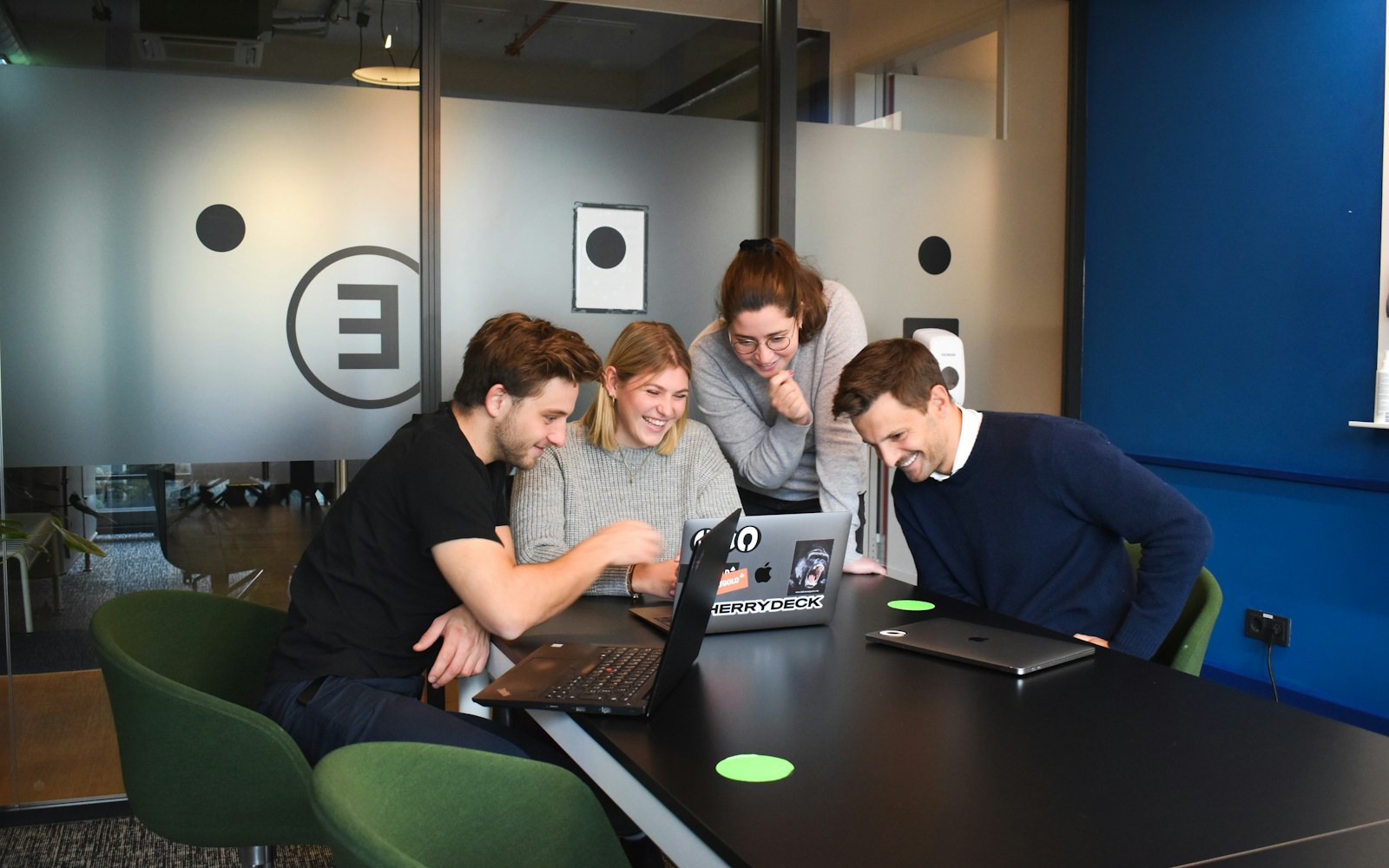 Small team seated together with laptop computers