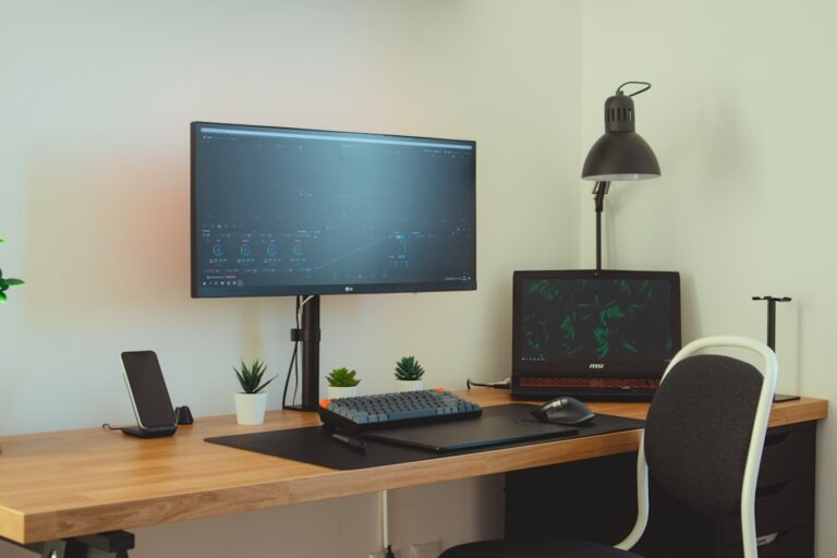 Desk with an external monitor, laptop and adjustable lamp
