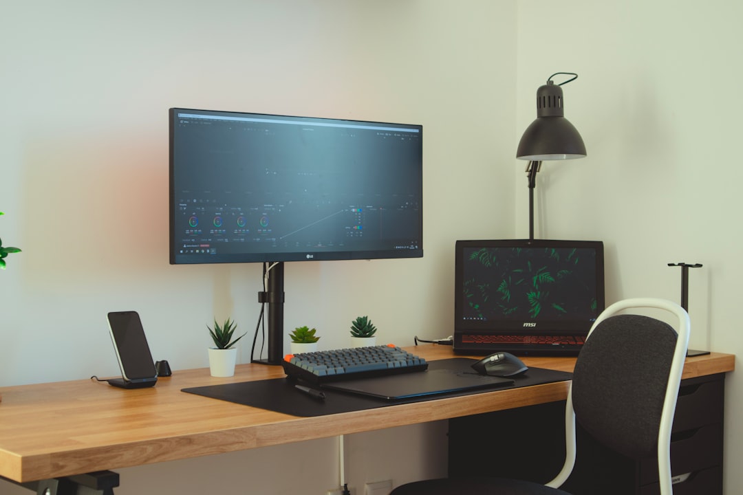 Desk with an external monitor, laptop and adjustable lamp