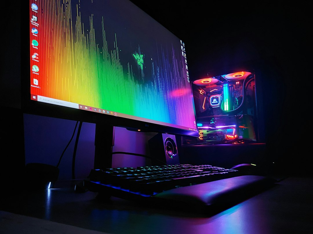 Desktop computer with illuminated components beside a monitor