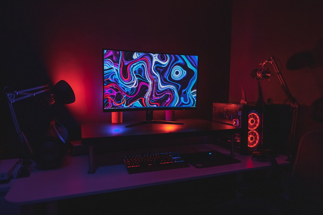 Gaming desk with a monitor, microphone arm and desktop computer