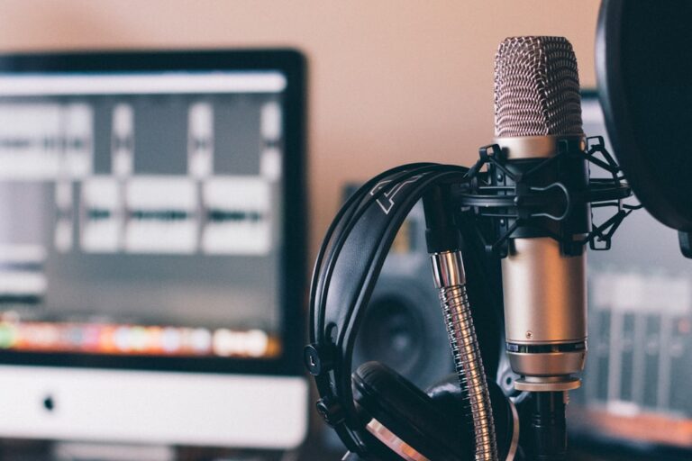 Microphone, headphones and recording software at a desk
