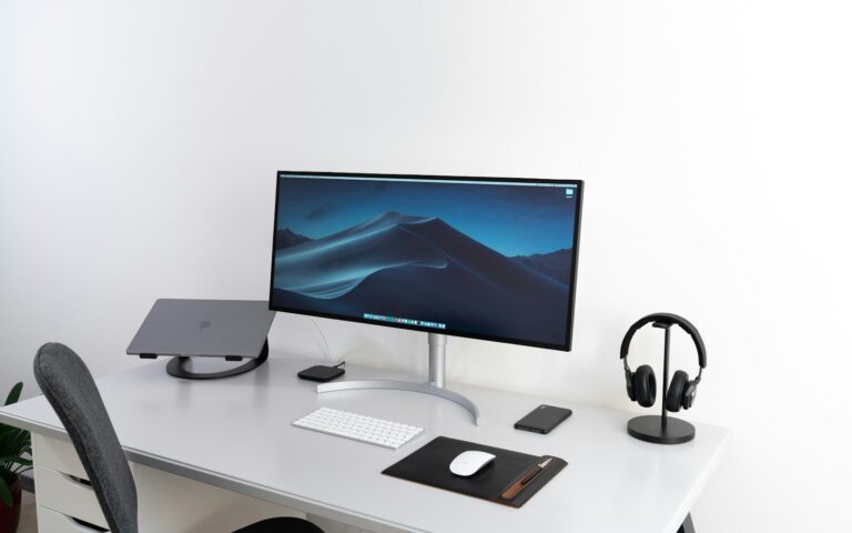 Desktop monitor, keyboard, and mouse arranged on a clean desk